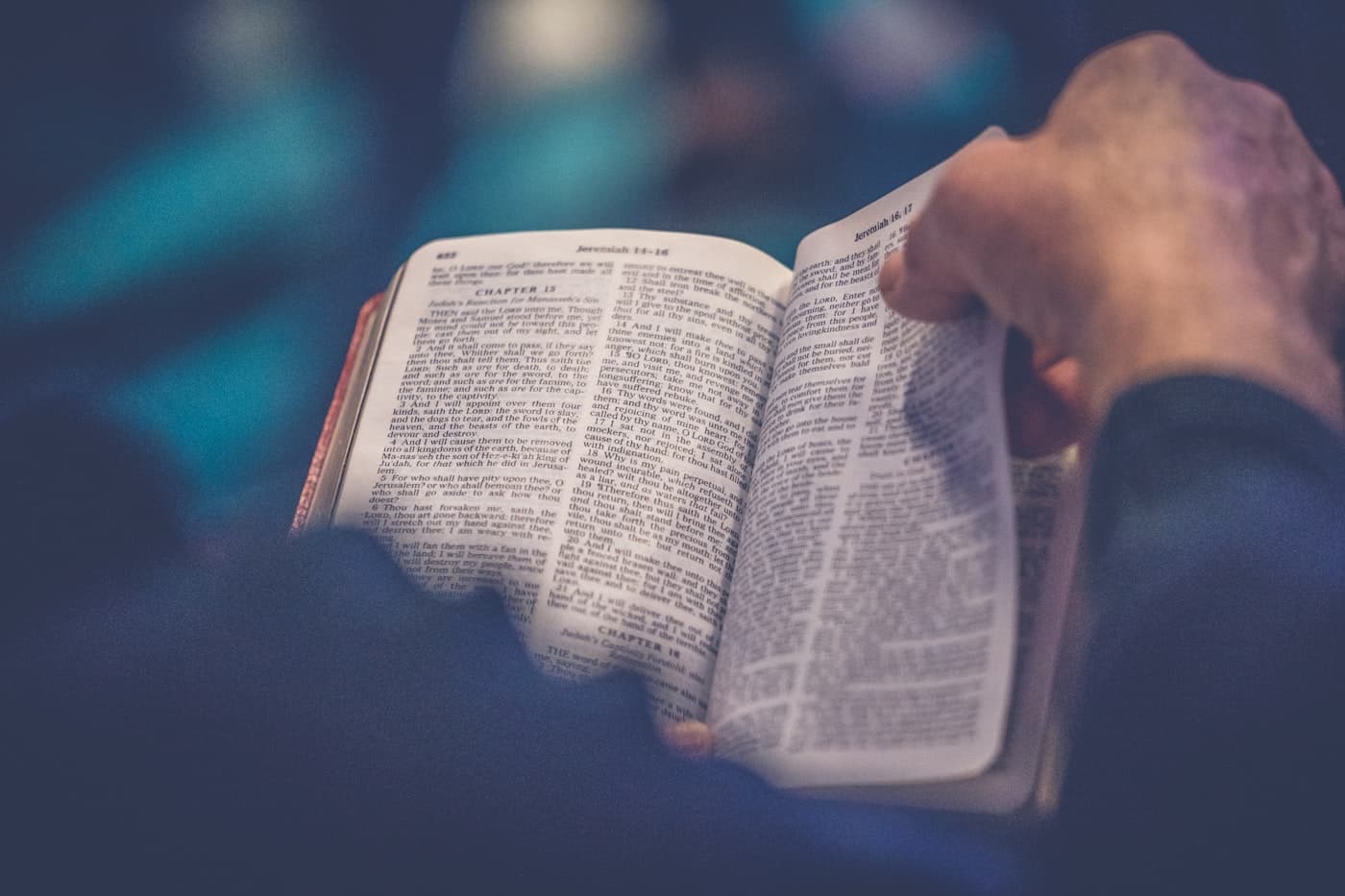 Open Bible held in two hands.